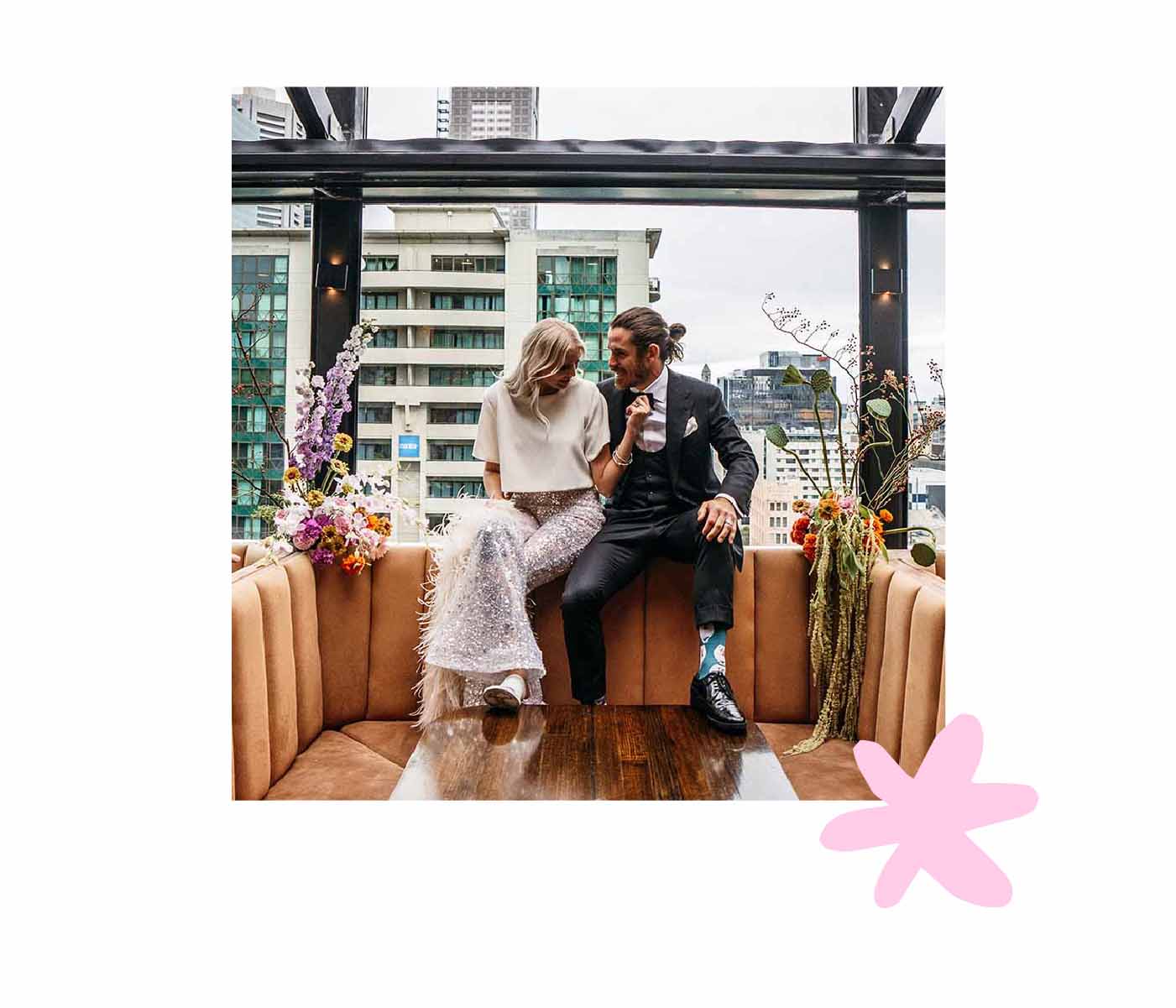 Event flower bouquets next to couple at table for their elopement
