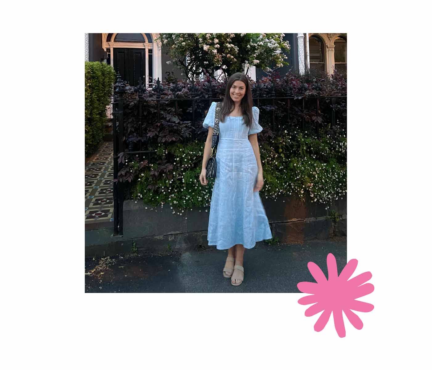 Anastasia Botica standing outside next to flowers in blue dress