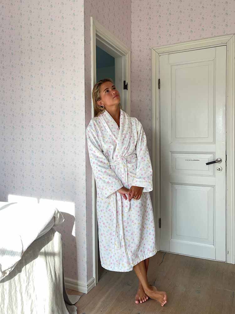 Image of Matilda Djerf in summer robe with a summer daisy pattern