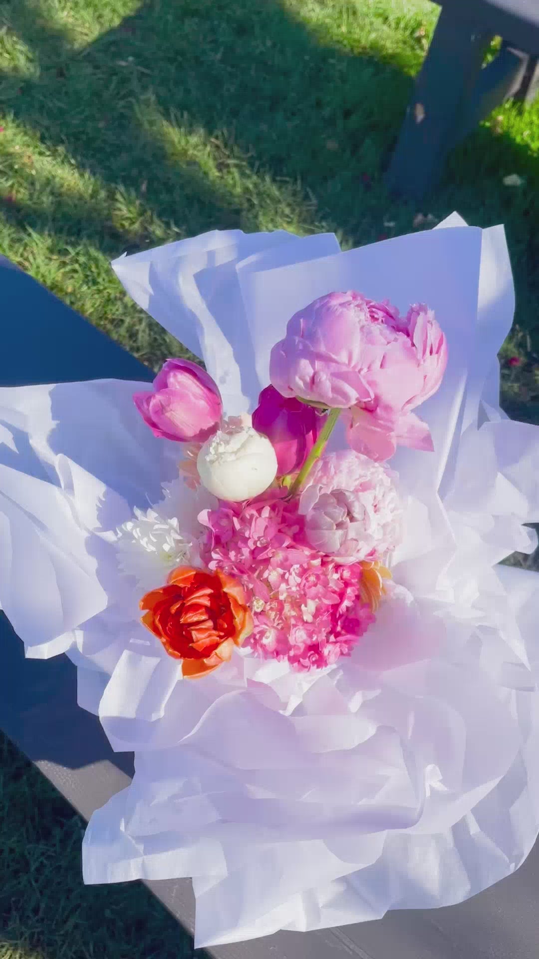 Urban Antidote spring mix bouquet showing peonies and tulips in white tissue paper