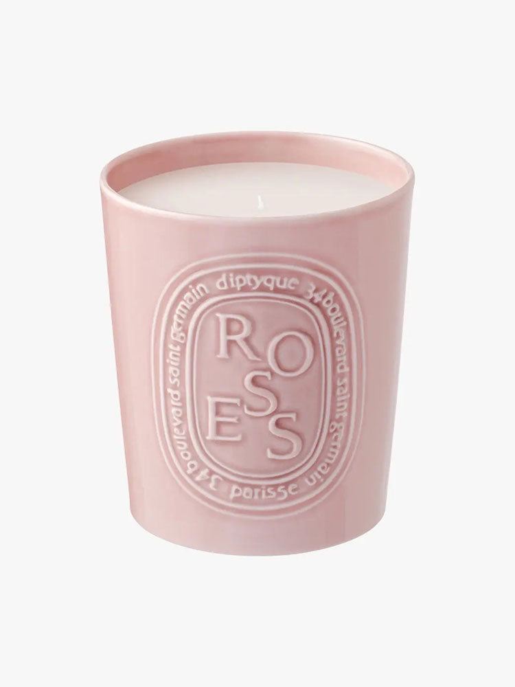 Candle with pink ceramic exterior and roses text by diptyque