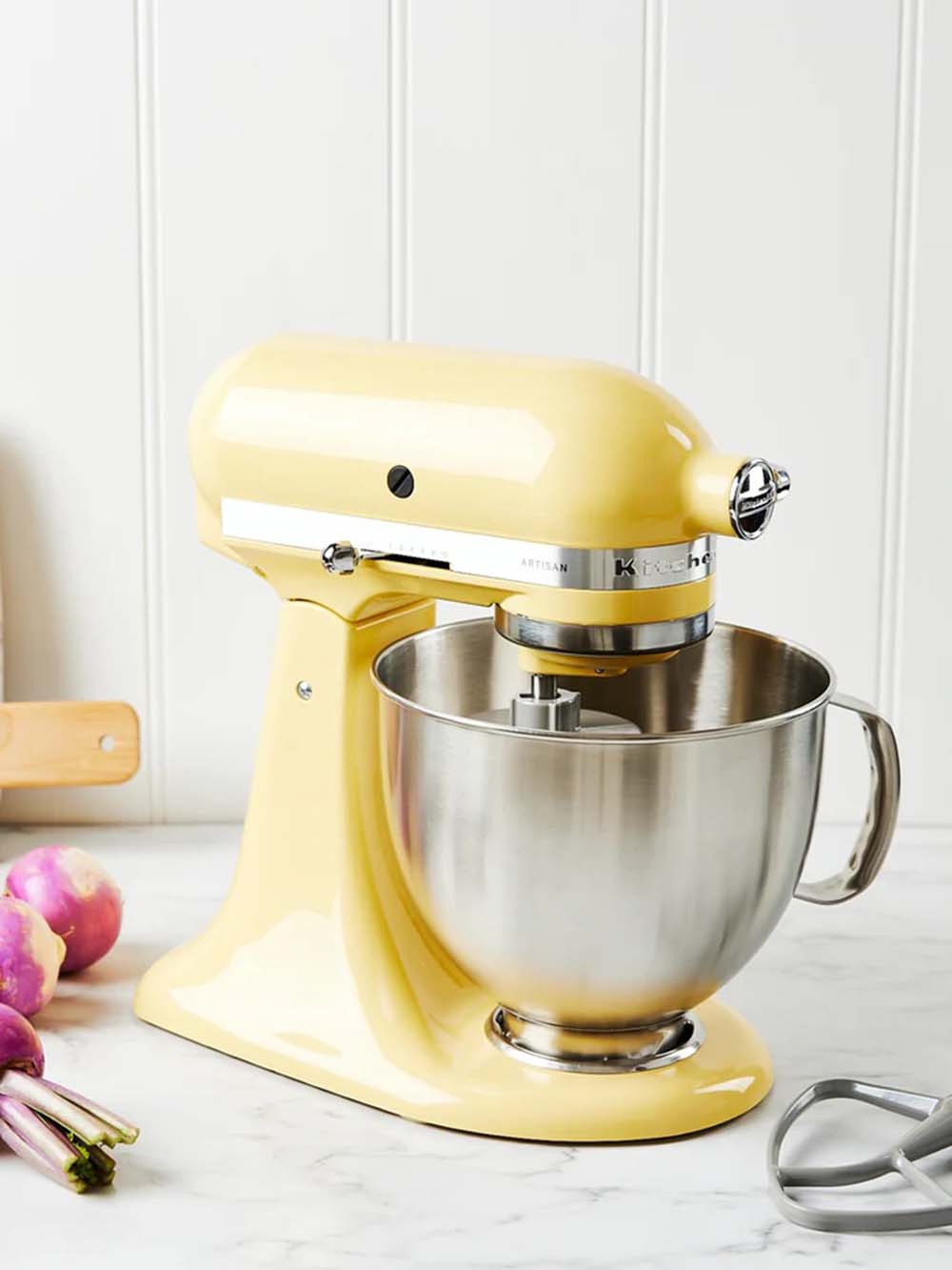 Image of stand mixer on bench by Kitchen Aid in pastel yellow