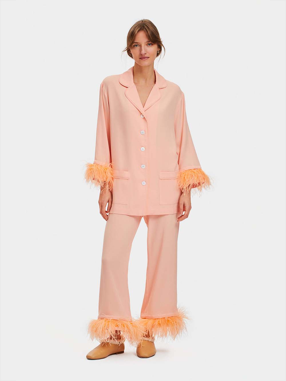 Peach coloured party pyjama with feathers by The Sleeper